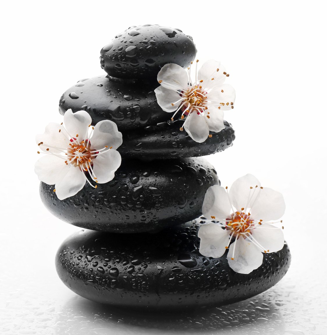 Stack of Spa Hot Stones and Flowers